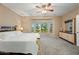 Spacious main bedroom with a ceiling fan and a large dresser and bay window at 5318 W Grenadine Rd, Laveen, AZ 85339