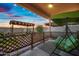 Covered patio features string lights, arbor, green swing, and decorative fence, perfect for outdoor enjoyment at 5318 W Grenadine Rd, Laveen, AZ 85339