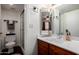 Bright bathroom featuring a modern vanity with spacious countertop, framed mirror, and walk-in shower at 533 W Guadalupe Rd # 1001, Mesa, AZ 85210