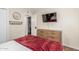 The bedroom has a wooden dresser and is equipped with a mounted TV at 533 W Guadalupe Rd # 1001, Mesa, AZ 85210