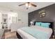 This bedroom includes ensuite bathroom access and dark accent wall with shelving at 533 W Guadalupe Rd # 1001, Mesa, AZ 85210