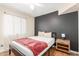 This bedroom boasts natural light, a sleek bed frame, and a dark accent wall at 533 W Guadalupe Rd # 1001, Mesa, AZ 85210