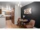 Charming dining space with black accent wall, hardwood floors and barn door at 533 W Guadalupe Rd # 1001, Mesa, AZ 85210