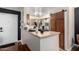 View of kitchen area with breakfast bar, stainless steel appliances and sliding wooden barn door at 533 W Guadalupe Rd # 1001, Mesa, AZ 85210