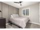 Cozy bedroom featuring a neutral color palette, ceiling fan, and a bright window at 5333 E Catalina Ave, Mesa, AZ 85206