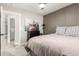 Stylish bedroom with a unique accent wall, plush carpet, and a view to the bathroom at 5333 E Catalina Ave, Mesa, AZ 85206