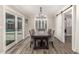 Elegant dining room featuring wood floors, a chandelier, and sliding glass doors to the pool at 5333 E Catalina Ave, Mesa, AZ 85206