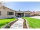 Beautiful home showcasing stone accents, shutters, a lush front lawn, and a welcoming two-car garage at 5333 E Catalina Ave, Mesa, AZ 85206