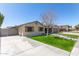 Attractive home featuring stone accents, shutters, a manicured lawn, and an expansive driveway at 5333 E Catalina Ave, Mesa, AZ 85206
