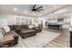 Cozy living room featuring wood floors, a plush rug, and an open floor plan to the kitchen at 5333 E Catalina Ave, Mesa, AZ 85206