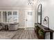 Bright living room featuring wood floors, a plush rug, and an elegant entryway at 5333 E Catalina Ave, Mesa, AZ 85206