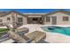 This covered patio includes a grill, an outdoor television and lounging area with easy access to the pool at 5333 E Catalina Ave, Mesa, AZ 85206