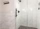 Stylish shower features gray-toned marble tile and glass surround, offering a spa-like experience at 5333 E Catalina Ave, Mesa, AZ 85206