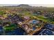 Aerial view of the community including golf course, homes, and water park at 6279 S Martingale Ct, Gilbert, AZ 85298