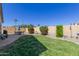 Spacious backyard complete with lush lawn, patio furniture set, and vibrant bougainvillea bushes at 6279 S Martingale Ct, Gilbert, AZ 85298
