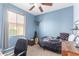 Comfortable bedroom featuring natural light, a full-sized bed, and guitar in the corner at 6279 S Martingale Ct, Gilbert, AZ 85298