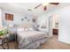 Relaxing bedroom with a queen bed, soft lighting, and an arched doorway to the bathroom at 6279 S Martingale Ct, Gilbert, AZ 85298