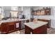Open concept kitchen featuring stainless appliances, granite countertops, an island, and dark cabinetry at 6279 S Martingale Ct, Gilbert, AZ 85298