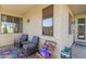 Relaxing covered patio featuring comfortable seating with a view of the backyard at 6279 S Martingale Ct, Gilbert, AZ 85298