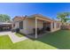 An outdoor patio features artificial grass and a covered area for dining with backyard views at 640 E Browning Way, Chandler, AZ 85286