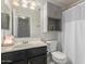 Bathroom with decorative mirror, shower with curtain, and drawers under the sink at 640 E Browning Way, Chandler, AZ 85286