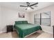 Cozy bedroom featuring light wood floors, ceiling fan and neutral walls at 640 E Browning Way, Chandler, AZ 85286