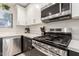 Close up view of the stainless steel gas range with matching microwave and designer white countertops at 640 E Browning Way, Chandler, AZ 85286