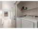Bright laundry room with sliding door, washer and dryer, plus storage shelves at 640 E Browning Way, Chandler, AZ 85286