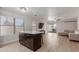 Bright open-concept with island, seamlessly connecting living, dining, and kitchen areas with modern flooring at 640 E Browning Way, Chandler, AZ 85286