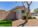Side view of a single-story home with stucco exterior, xeriscape yard, and block wall at 640 E Browning Way, Chandler, AZ 85286