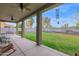 Spacious covered patio with a seating area overlooking the lush green backyard at 6793 W Angela Dr, Glendale, AZ 85308