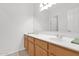 Bright bathroom features a double vanity with oak cabinets and ample countertop space at 6793 W Angela Dr, Glendale, AZ 85308