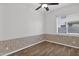 Bedroom featuring wood-look floors, a ceiling fan, and a window for natural light at 6793 W Angela Dr, Glendale, AZ 85308