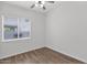 Bedroom featuring wood-look floors, a ceiling fan, and a window for natural light at 6793 W Angela Dr, Glendale, AZ 85308