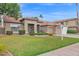 Inviting single-Gathering home featuring a well-manicured lawn and a symmetrical design, complemented by a tile roof and desert landscaping at 6793 W Angela Dr, Glendale, AZ 85308