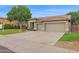 Traditional home with a three-car garage, manicured landscaping, and a tile roof at 6793 W Angela Dr, Glendale, AZ 85308
