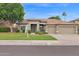 Charming home with a well-maintained lawn, mature landscaping, and a three-car garage at 6793 W Angela Dr, Glendale, AZ 85308