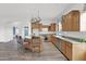 Spacious kitchen boasting wooden cabinetry, a granite island with seating, and modern appliances, perfect for cooking and entertaining at 6793 W Angela Dr, Glendale, AZ 85308