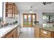 Open kitchen with granite countertops, stainless steel dishwasher, and a set of backyard facing french doors at 6793 W Angela Dr, Glendale, AZ 85308