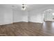 Spacious living room with wood floors, white walls, and an arched doorway at 6793 W Angela Dr, Glendale, AZ 85308