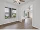 Open living room with windows, neutral walls, and wood-look floors, ready for personalization and comfort at 6793 W Angela Dr, Glendale, AZ 85308