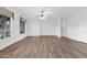 Spacious living room with wood floors, white walls, and large windows at 6793 W Angela Dr, Glendale, AZ 85308