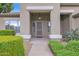 Charming front porch with a decorative light fixture, surrounded by manicured greenery, inviting guests to a well-maintained home at 6793 W Angela Dr, Glendale, AZ 85308