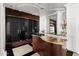 Elegant bar area featuring a custom wood counter, glass enclosed wine storage, and designer finishes at 7046 N 59Th Pl, Paradise Valley, AZ 85253