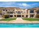 Grand home boasts manicured landscaping, stone pathway, and a large backyard pool at 7046 N 59Th Pl, Paradise Valley, AZ 85253