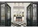 Stunning foyer showcasing black and white tile flooring and elegant lighting that leads to a bright living space at 7046 N 59Th Pl, Paradise Valley, AZ 85253