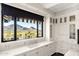 Bright kitchen with mountain views from the sink, marble countertops, and custom cabinetry at 7046 N 59Th Pl, Paradise Valley, AZ 85253