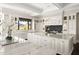 Spacious kitchen with double islands, marble countertops, custom cabinets, and views of the landscape at 7046 N 59Th Pl, Paradise Valley, AZ 85253