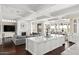 Open-concept living space with a fireplace, wood flooring, and a large kitchen island at 7046 N 59Th Pl, Paradise Valley, AZ 85253