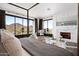 Bright main bedroom features a stone fireplace and a glass door leading to a balcony with mountain views at 7046 N 59Th Pl, Paradise Valley, AZ 85253
